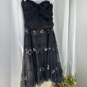 Beautifully detailed with lace, beading, and stitched flowers.